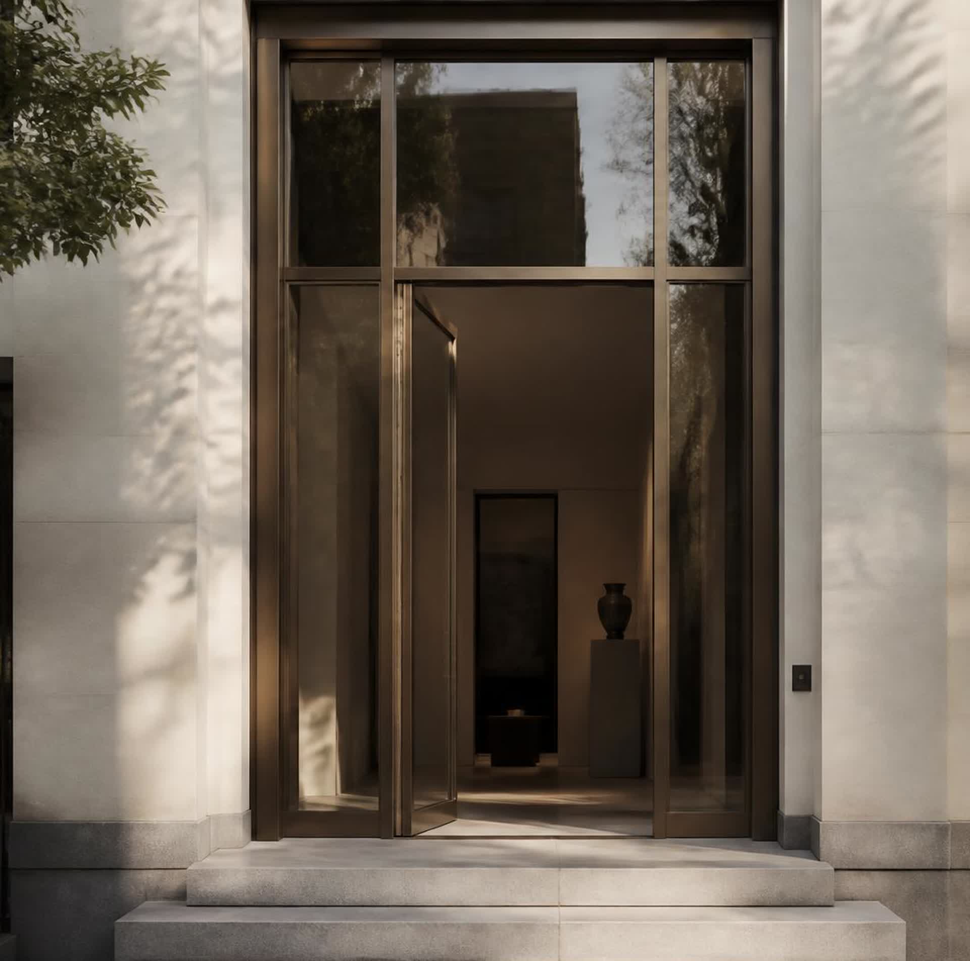 A bronze-framed entrance doorway of a discreet townhouse office in morning light